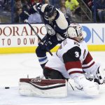Columbus Blue Jackets' Nick Foligno, top, scores against Arizona Coyotes' Louis Domingue during the second period of an NHL hockey game, Monday, Dec. 5, 2016, in Columbus, Ohio. (AP Photo/Jay LaPrete)