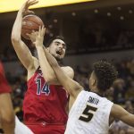 Arizona's Dusan Ristic, left, is fouled by Missouri's Mitchell Smith, right, as he shoots during the second half of an NCAA college basketball game Saturday, Dec. 10, 2016, in Columbia, Mo. Arizona won the game 79-60. (AP Photo/L.G. Patterson)