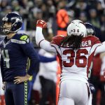 Seattle Seahawks kicker Steven Hauschka, left, and Arizona Cardinals free safety D.J. Swearinger (36) react after Hauschka missed a point after a touchdown in the fourth quarter of an NFL football game, Saturday, Dec. 24, 2016, in Seattle.  (AP Photo/Ted S. Warren)