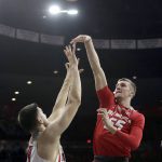 New Mexico forward Connor MacDougall (55) shoots over Arizona center Dusan Ristic during the first half of an NCAA college basketball game, Tuesday, Dec. 20, 2016, in Tucson, Ariz. (AP Photo/Rick Scuteri)
