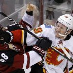 Calgary Flames left wing Matthew Tkachuk (19) mixes it up with Arizona Coyotes left wing Jordan Martinook (48) during the second period of an NHL hockey game Thursday, Dec. 8, 2016, in Glendale, Ariz. (AP Photo/Ross D. Franklin)