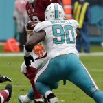 Arizona Cardinals quarterback Carson Palmer (3) is sacked by Miami Dolphins defensive end Cameron Wake, obstructed, during the second half of an NFL football game, Sunday, Dec. 11, 2016, in Miami Gardens, Fla. To the right is Miami Dolphins defensive tackle Earl Mitchell (90). (AP Photo/Wilfredo Lee)