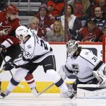 Arizona Coyotes center Martin Hanzal, left, sends the puck past Los Angeles Kings goalie Peter Budaj (31) for a goal as Kings defenseman Derek Forbort (24) defends during the first period of an NHL hockey game Thursday, Dec. 1, 2016, in Glendale, Ariz. (AP Photo/Ross D. Franklin)