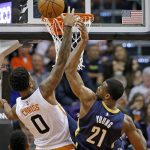 Indiana Pacers forward Thaddeus Young (21) blocks the shot of Phoenix Suns forward Marquese Chriss (0) during the first half of an NBA basketball game Wednesday, Dec. 7, 2016, in Phoenix. (AP Photo/Ross D. Franklin)