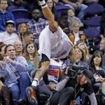 Phoenix Suns center Tyson Chandler leaps in vain for a loose ball as he goes into the audience during the first half of an NBA basketball game against the Indiana Pacers on Wednesday, Dec. 7, 2016, in Phoenix. (AP Photo/Ross D. Franklin)