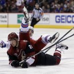 Arizona Coyotes left wing Brendan Perlini (29) and New York Rangers right wing Jesper Fast fall to the ice during the first period during of an NHL hockey game, Thursday, Dec. 29, 2016, in Glendale, Ariz. (AP Photo/Rick Scuteri)