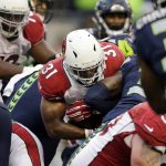 Arizona Cardinals' David Johnson (31) scores on a one-yard run against the Seattle Seahawks in the second half of an NFL football game, Saturday, Dec. 24, 2016, in Seattle. (AP Photo/John Froschauer)