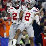 Ohio State safety Malik Hooker (24) celebrates his interception against Clemson with teammate Marshon Lattimore (2) during the first half of the Fiesta Bowl NCAA college football playoff semifinal, Saturday, Dec. 31, 2016, in Glendale, Ariz. (AP Photo/Ross D. Franklin)