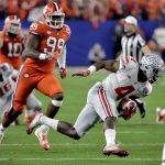 Ohio State running back Curtis Samuel (4) carries as Clemson defensive end Clelin Ferrell (99) pursues during the first half of the Fiesta Bowl NCAA college football game, Saturday, Dec. 31, 2016, in Glendale, Ariz. (AP Photo/Rick Scuteri)