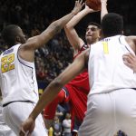 Arizona's Dusan Ristic, center, shoots over California's Kingsley Okoroh (22) and Ivan Rabb (1) during the first half of an NCAA college basketball game, Friday, Dec. 30, 2016, in Berkeley, Calif. (AP Photo/George Nikitin)
