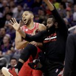 Houston Rockets guard Eric Gordon celebrates his basket against the Phoenix Suns with Rockets guard James Harden, right, during the second half of an NBA basketball game, Wednesday, Dec. 21, 2016, in Phoenix. (AP Photo/Matt York)