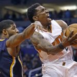 Phoenix Suns guard Eric Bledsoe, right, grimaces as he get fouled by Indiana Pacers forward Paul George (13) as Bledsoe goes up for a shot during the second half of an NBA basketball game Wednesday, Dec. 7, 2016, in Phoenix. The Pacers defeated the Suns 109-94. (AP Photo/Ross D. Franklin)