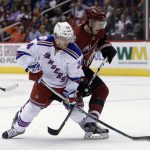 New York Rangers center Oscar Lindberg (24) and Arizona Coyotes right wing Shane Doan vie for the puck during the first period of an NHL hockey game, Thursday, Dec. 29, 2016, in Glendale, Ariz. (AP Photo/Rick Scuteri)