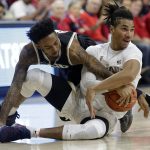 Grand Canyon guard Shaq Carr, left, and Arizona forward Keanu Pinder battle for a loose ball during the first half of an NCAA college basketball game, Wednesday, Dec. 14, 2016, in Tucson, Ariz. (AP Photo/Rick Scuteri)