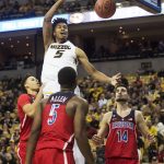 Missouri's Mitchell Smith, top, dunks the ball over Arizona's Chance Comanche, left, Kadeem Allen, center, and Dusan Ristic, right, during the first half of an NCAA college basketball game Saturday, Dec. 10, 2016, in Columbia, Mo. (AP Photo/L.G. Patterson)