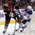Arizona Coyotes defenseman Michael Stone shields the puck from Edmonton Oilers left wing Drake Caggiula (36) in the first period during an NHL hockey game, Wednesday, Dec. 21, 2016, in Glendale, Ariz. (AP Photo/Rick Scuteri)