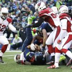 Seattle Seahawks quarterback Russell Wilson is upended as he keeps the ball on a touchdown attempt against the Arizona Cardinals in the first half of an NFL football game, Saturday, Dec. 24, 2016, in Seattle. (AP Photo/Ted S. Warren)