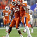 Clemson's Carlos Watkins (94) and Clelin Ferrell (99) celebrate a stop against Ohio State during the first half of the Fiesta Bowl NCAA college football playoff semifinal, Saturday, Dec. 31, 2016, in Glendale, Ariz. (AP Photo/Ross D. Franklin)