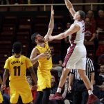 Stanford forward Reid Travis, right, shoots over Arizona State forward Ramon Vila, center, during the first half of an NCAA college basketball game Friday, Dec. 30, 2016, in Stanford, Calif. (AP Photo/Marcio Jose Sanchez)