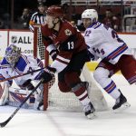 Arizona Coyotes center Peter Holland (13) skates away from New York Rangers' Nick Holden (22) in front of goalie Antti Raanta during the second period of an NHL hockey game, Thursday, Dec. 29, 2016, in Glendale, Ariz. (AP Photo/Rick Scuteri)