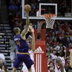 Phoenix Suns center Tyson Chandler (4) shoots over Houston Rockets forward Ryan Anderson (3) as guard James Harden (13) looks on in the first half of an NBA basketball game on Monday, Dec. 26, 2016 in Houston. (AP Photo/Bob Levey)