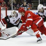Arizona Coyotes goalie Mike Smith (41) stops a shot by Detroit Red Wings left wing Thomas Vanek (62) as Josh Jooris (86) defends in the second period of an NHL hockey game Tuesday, Dec. 13, 2016, in Detroit. (AP Photo/Paul Sancya)