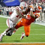 Clemson running back C.J. Fuller (27) makes a touchdown catch as Ohio State cornerback C.J. Saunders (17) defends during the first half of the Fiesta Bowl NCAA college football playoff semifinal, Saturday, Dec. 31, 2016, in Glendale, Ariz. (AP Photo/Ross D. Franklin)
