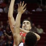Arizona's Dusan Ristic shoots over Texas A&M's Tyler Davis (34) during the first half of an NCAA college basketball game, Saturday, Dec. 17, 2016, in Houston. (AP Photo/David J. Phillip)