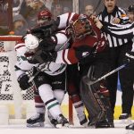 Arizona Coyotes goalie Mike Smith (41) and defenseman Anthony DeAngelo (77) tangle with Dallas Stars' Curtis McKenzie (11) after a play in front of the net during the second period of an NHL hockey game, Tuesday, Dec. 27, 2016, in Glendale, Ariz. (AP Photo/Ralph Freso)