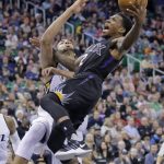 Phoenix Suns guard Eric Bledsoe (2) goes to the basket as Utah Jazz center Rudy Gobert, rear, defends in the first half during an NBA basketball game Saturday, Dec. 31, 2016, in Salt Lake City. (AP Photo/Rick Bowmer)