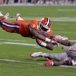 Clemson running back Wayne Gallman (9) is tackled by Ohio State cornerback C.J. Saunders (17) during the second half of the Fiesta Bowl NCAA college football game, Saturday, Dec. 31, 2016, in Glendale, Ariz. (AP Photo/Rick Scuteri)
