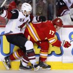 Arizona Coyotes' Martin Hanzal, left, from the Czech Republic, hits Calgary Flames' Lance Bouma during the second period of an NHL hockey game Saturday, Dec. 31, 2016, in Calgary, Alberta. (Larry MacDougal/The Canadian Press via AP)