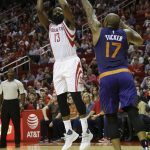 Houston Rockets guard James Harden (13) shoots over Phoenix Suns forward P.J. Tucker (17) in the first half of an NBA basketball game on Monday, Dec. 26, 2016 in Houston. (AP Photo/Bob Levey)