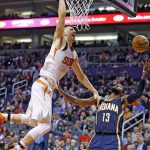 Phoenix Suns center Alex Len, left, loses control of the ball as he goes up for a dunk against Indiana Pacers forward Paul George (13) during the second half of an NBA basketball game, Wednesday, Dec. 7, 2016, in Phoenix. The Pacers defeated the Suns 109-94. (AP Photo/Ross D. Franklin)