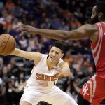 Phoenix Suns guard Devin Booker (1) loses the ball as Houston Rockets guard James Harden (13) defends during the second half of an NBA basketball game, Wednesday, Dec. 21, 2016, in Phoenix. (AP Photo/Matt York)