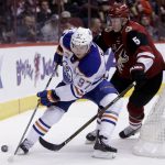 Edmonton Oilers center Connor McDavid (97) shields Arizona Coyotes defenseman Connor Murphy from the puck in the first period during an NHL hockey game, Wednesday, Dec. 21, 2016, in Glendale, Ariz. (AP Photo/Rick Scuteri)