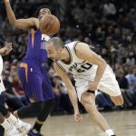 Phoenix Suns forward T.J. Warren, left, causes San Antonio Spurs guard Manu Ginobili (20) to lose control of the ball during the first half of an NBA basketball game, Wednesday, Dec. 28, 2016, in San Antonio. (AP Photo/Eric Gay)
