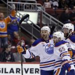 Edmonton Oilers center Mark Letestu (55) celebrates with Zack Kassian and Eric Gryba (62) after scoring a goal against the Arizona Coyotes in the first period during an NHL hockey game, Wednesday, Dec. 21, 2016, in Glendale, Ariz. (AP Photo/Rick Scuteri)
