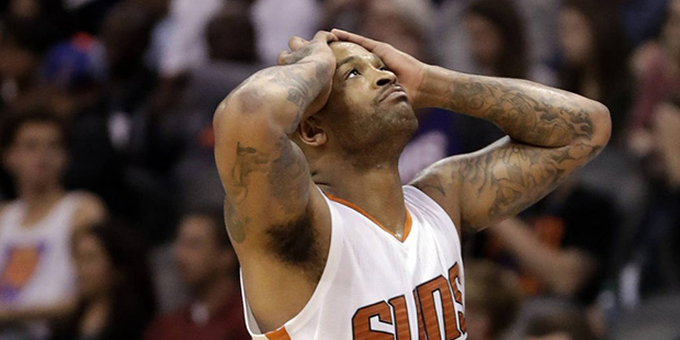 Phoenix Suns forward P.J. Tucker reacts to a foul call against him during the second half of the te...