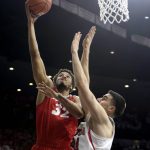 New Mexico forward Tim Williams (32) shoots over Arizona center Dusan Ristic during the first half of an NCAA college basketball game, Tuesday, Dec. 20, 2016, in Tucson, Ariz. (AP Photo/Rick Scuteri)