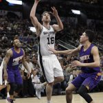San Antonio Spurs center Pau Gasol (16) shoots over Phoenix Suns guard Devin Booker (1) during the first half of an NBA basketball game, Wednesday, Dec. 28, 2016, in San Antonio. (AP Photo/Eric Gay)