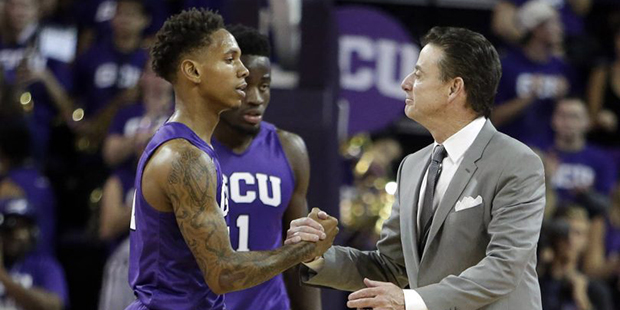 Louisville head coach Rick Pitino, right, talks to Grand Canyon guard DeWayne Russell (0) after an ...