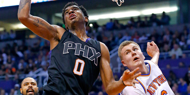 Phoenix Suns forward Marquese Chriss (0) beats New York Knicks forward Kristaps Porzingis (6) to th...