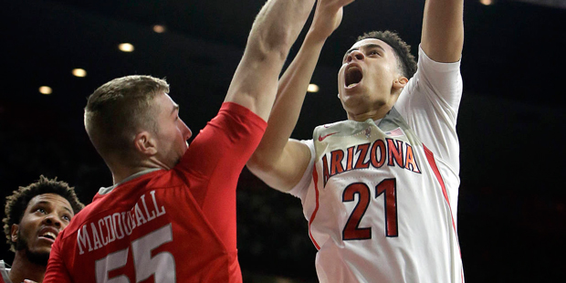 Arizona center Chance Comanche (21) shoots over New Mexico forward Connor MacDougall during the sec...