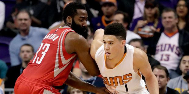 Phoenix Suns guard Devin Booker (1) drives against Houston Rockets guard James Harden (13) during t...