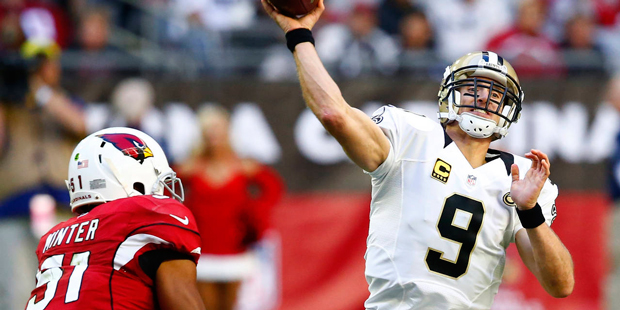 New Orleans Saints quarterback Drew Brees (9) throws as Arizona Cardinals middle linebacker Kevin M...