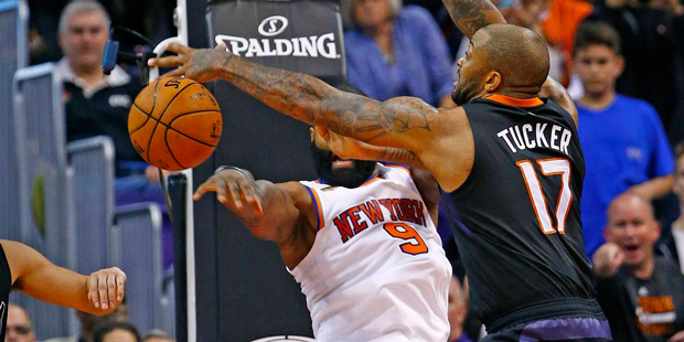Phoenix Suns forward P.J. Tucker (17) makes a defensive stop against New York Knicks center Kyle O'...