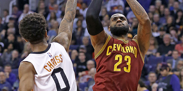 Cleveland Cavaliers forward LeBron James (23) shoots over Phoenix Suns forward Marquese Chriss (0) ...