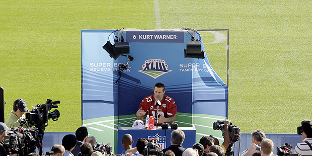 Arizona Cardinals quarterback Kurt Warner answers questions during the team's media day for Super B...
