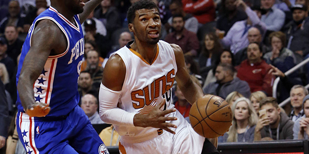 Phoenix Suns guard Ronnie Price, right, drives past Philadelphia 76ers guard JaKarr Sampson during ...